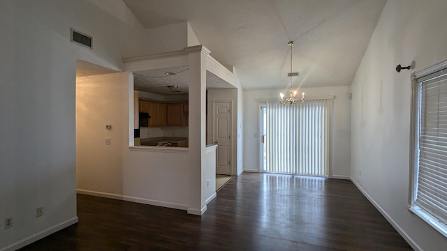 unfurnished dining area with an inviting chandelier, lofted ceiling, and dark hardwood / wood-style flooring