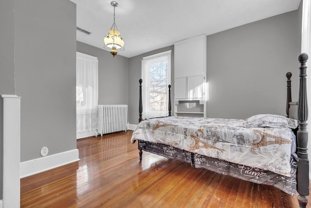 bedroom featuring radiator and wood-type flooring