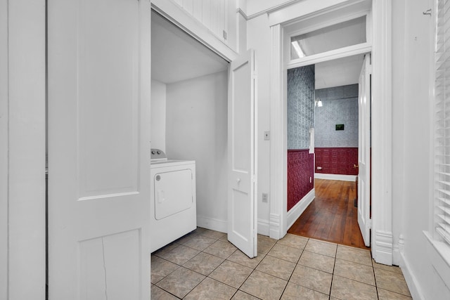 clothes washing area featuring washer / clothes dryer and light tile patterned floors