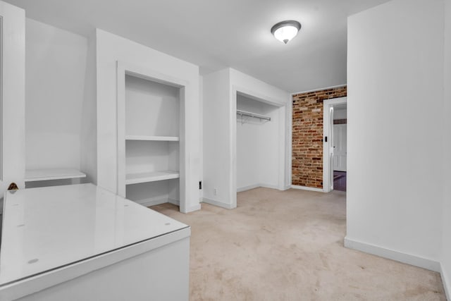 spacious closet with light colored carpet