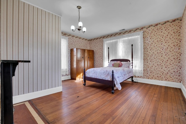 bedroom featuring hardwood / wood-style flooring and a chandelier