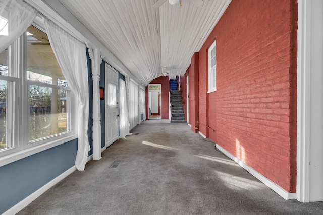 hall with brick wall and carpet