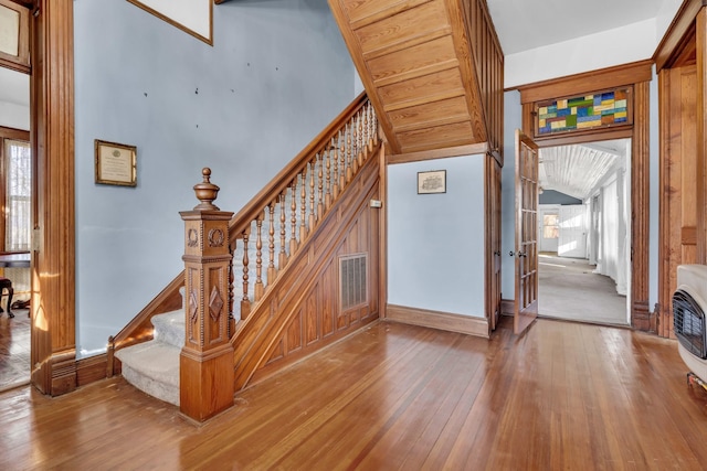 stairway with hardwood / wood-style floors and a wealth of natural light