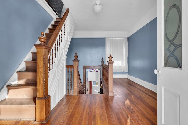 staircase with hardwood / wood-style floors