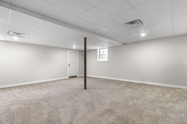 basement featuring carpet floors and a drop ceiling