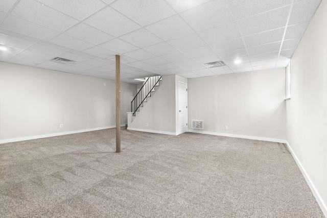 basement featuring carpet flooring and a paneled ceiling