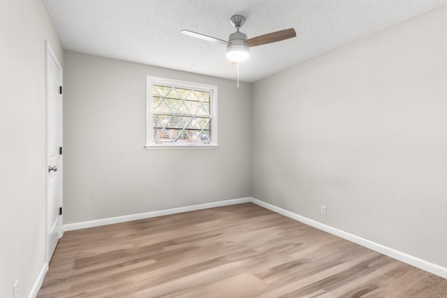 empty room featuring ceiling fan, a textured ceiling, and light wood-type flooring