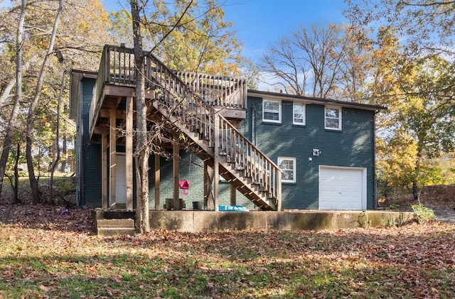 rear view of property featuring a garage