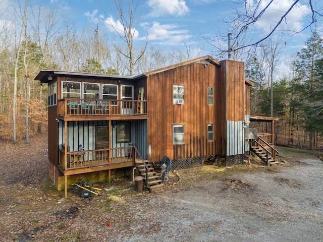 back of property with a sunroom