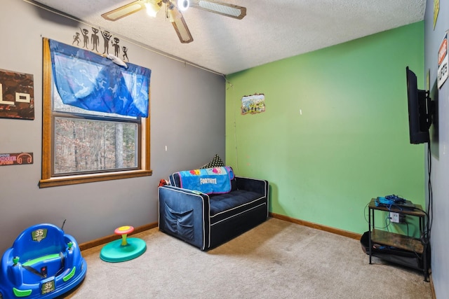 carpeted bedroom with ceiling fan and a textured ceiling