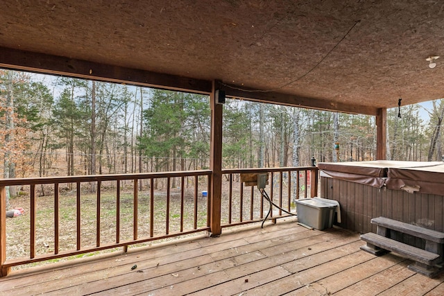 wooden terrace with a hot tub