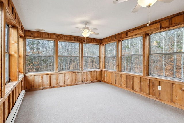 unfurnished sunroom with baseboard heating and ceiling fan