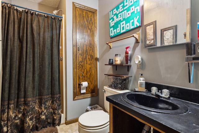 bathroom featuring walk in shower, vanity, and toilet