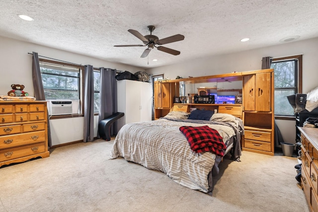 carpeted bedroom featuring ceiling fan, cooling unit, and a textured ceiling