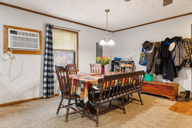 dining room featuring a textured ceiling, ornamental molding, carpet flooring, a wall unit AC, and a notable chandelier