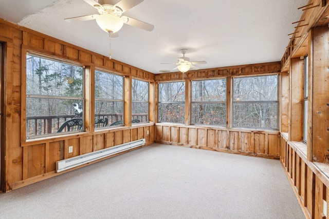 unfurnished sunroom with ceiling fan and a baseboard radiator