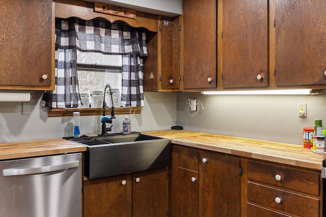 kitchen with stainless steel dishwasher, sink, and butcher block countertops