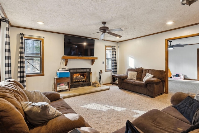 living room with crown molding, carpet flooring, and a large fireplace