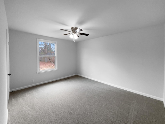 spare room with ceiling fan and carpet