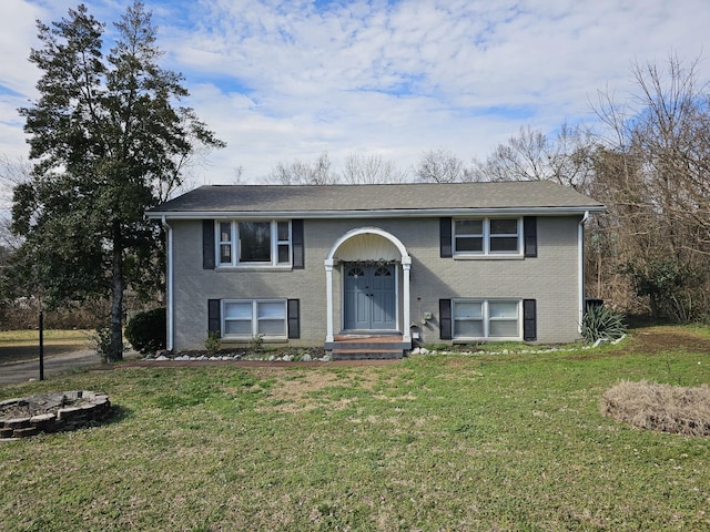 raised ranch with a front lawn