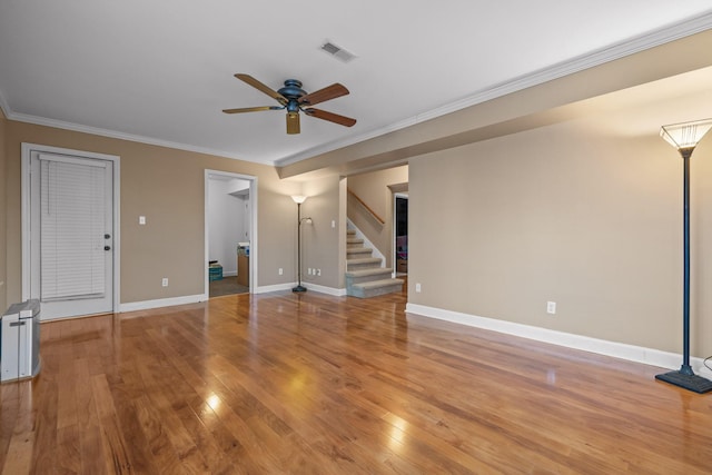 unfurnished living room featuring hardwood / wood-style flooring, ornamental molding, and ceiling fan