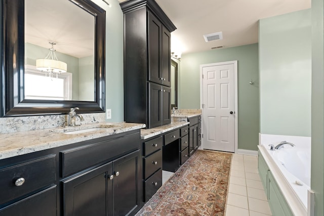 bathroom with vanity, a bath, and tile patterned flooring