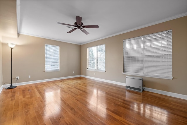 empty room featuring hardwood / wood-style flooring, ceiling fan, and ornamental molding