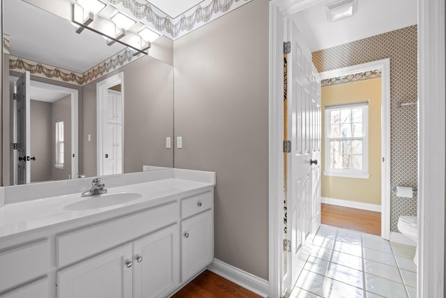 bathroom with vanity, tile patterned floors, and toilet