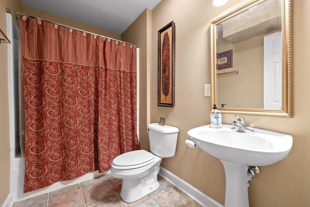 bathroom with tile patterned flooring, shower / bath combo, and toilet