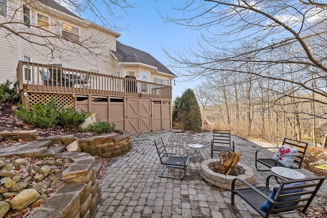 view of patio / terrace featuring a fire pit and a deck