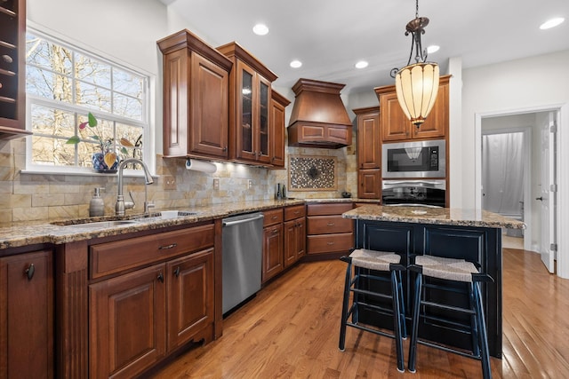 kitchen with sink, dishwasher, a kitchen island, built in microwave, and custom exhaust hood