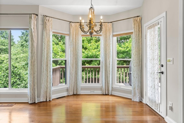 2108 Valleydale Ln, Signal Mountain, TN 37377 - unfurnished dining area featuring a chandelier, wood-type flooring, and baseboards
