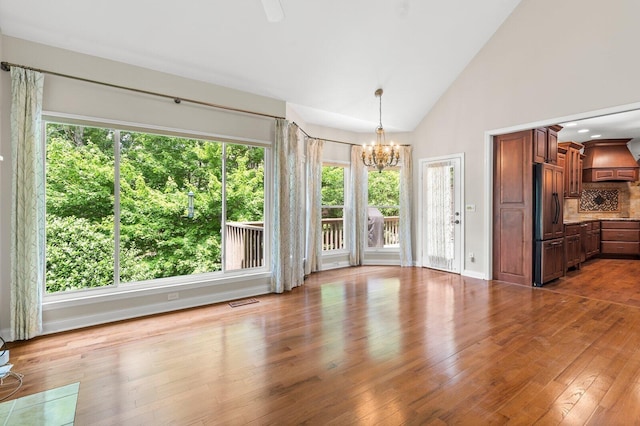 2108 Valleydale Ln, Signal Mountain, TN 37377 - unfurnished dining area featuring a chandelier, wood finished floors, and high vaulted ceiling