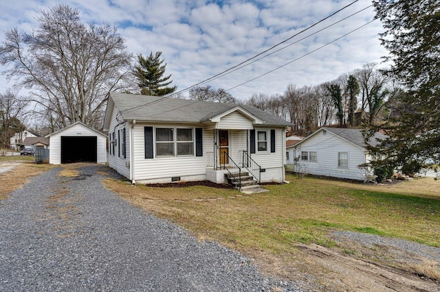 bungalow-style home featuring an outbuilding, a garage, and a front lawn