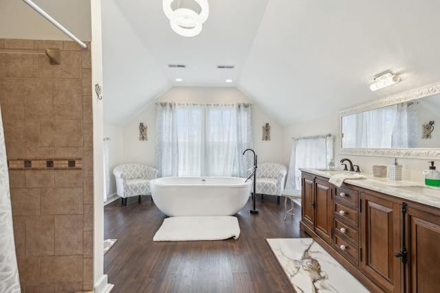 479 Elora Rd, Elora, TN 37328 - full bath featuring a freestanding bath, double vanity, lofted ceiling, wood finished floors, and a tile shower