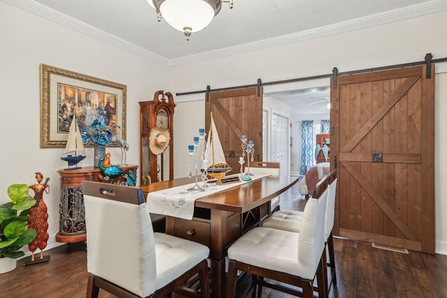 479 Elora Rd, Elora, TN 37328 - dining area featuring a barn door, wood finished floors, baseboards, and ornamental molding