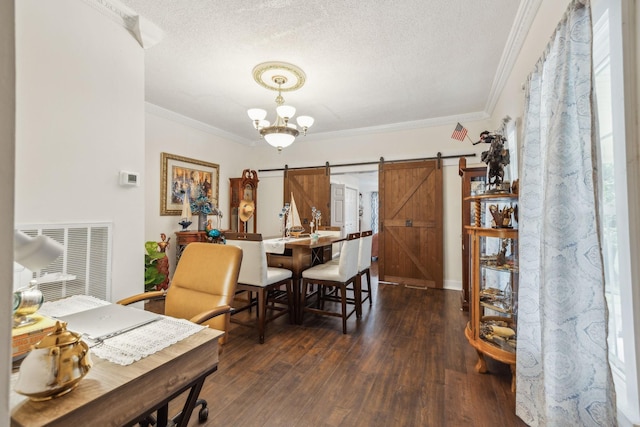 479 Elora Rd, Elora, TN 37328 - dining room with a barn door, a textured ceiling, crown molding, dark wood-type flooring, and a chandelier