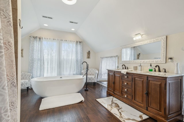 479 Elora Rd, Elora, TN 37328 - full bathroom with wood finished floors, lofted ceiling, a freestanding bath, and double vanity