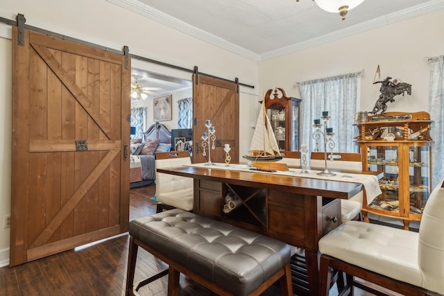 479 Elora Rd, Elora, TN 37328 - dining space with a barn door, hardwood / wood-style flooring, and crown molding