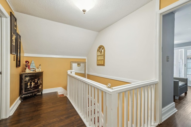 479 Elora Rd, Elora, TN 37328 - hallway featuring wood finished floors, vaulted ceiling, baseboards, an upstairs landing, and a textured ceiling