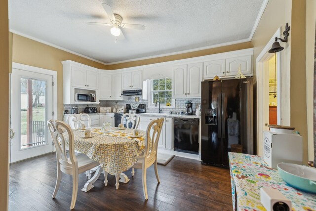 479 Elora Rd, Elora, TN 37328 - kitchen with black appliances, under cabinet range hood, white cabinets, backsplash, and ornamental molding