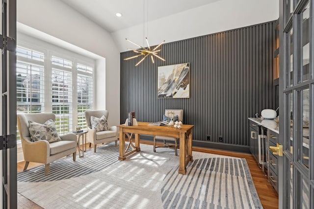 home office featuring lofted ceiling, recessed lighting, wood finished floors, and an inviting chandelier