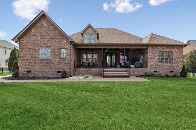 back of house featuring a yard, brick siding, crawl space, and roof with shingles