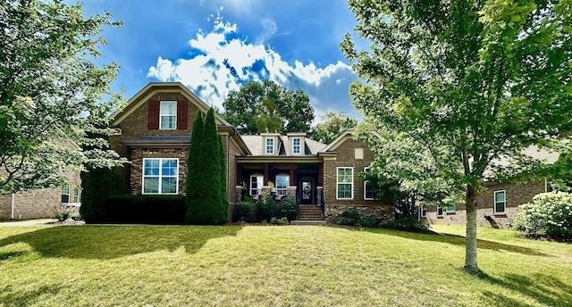 craftsman house featuring a porch and a front yard