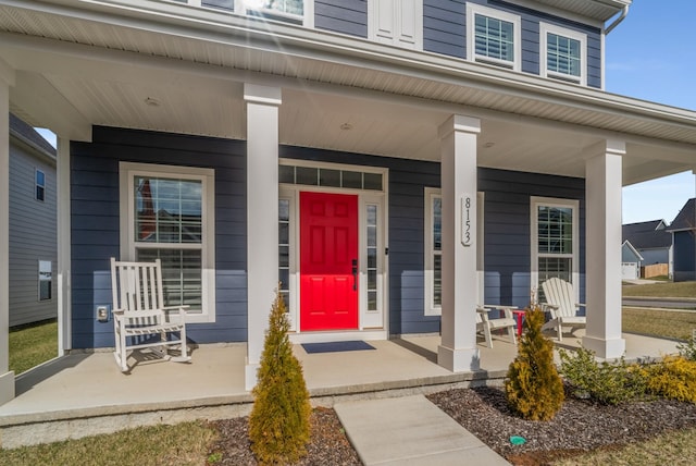 view of exterior entry featuring covered porch