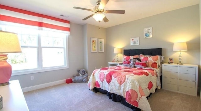 bedroom featuring light carpet and ceiling fan