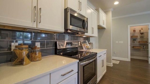 kitchen featuring crown molding, dark hardwood / wood-style flooring, stainless steel appliances, decorative backsplash, and white cabinets