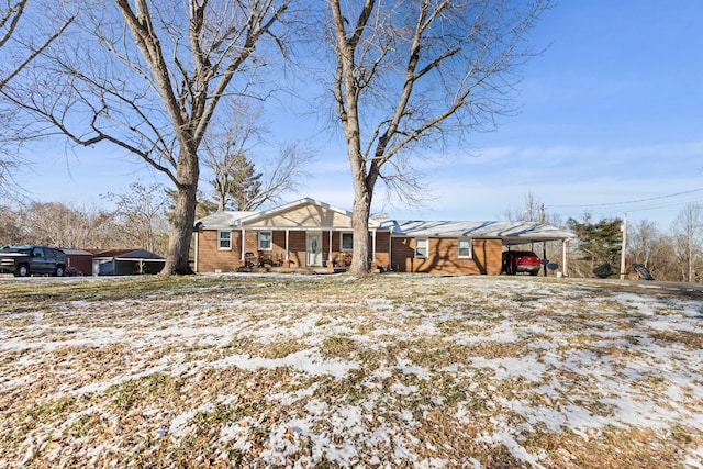 exterior space with a porch and brick siding