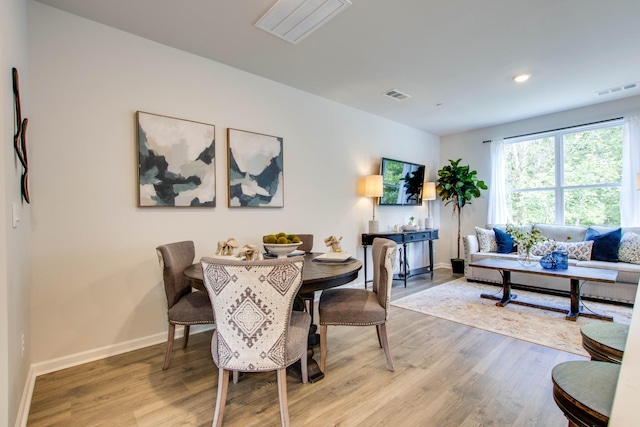 dining space with hardwood / wood-style floors