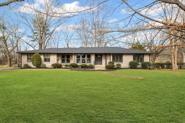 ranch-style home with a front lawn